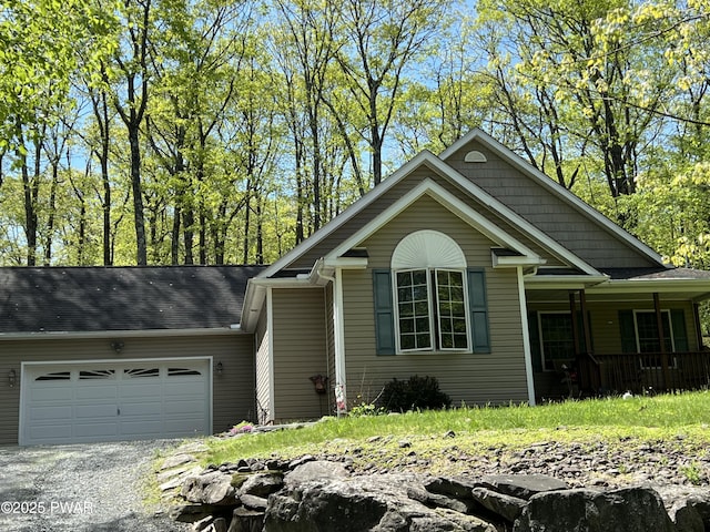 111 Bluestone Dr, Lords Valley, PA 18428 - view of front of property featuring a garage, gravel driveway, and a porch