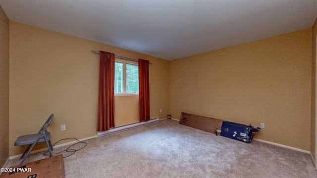 empty room featuring carpet and baseboard heating