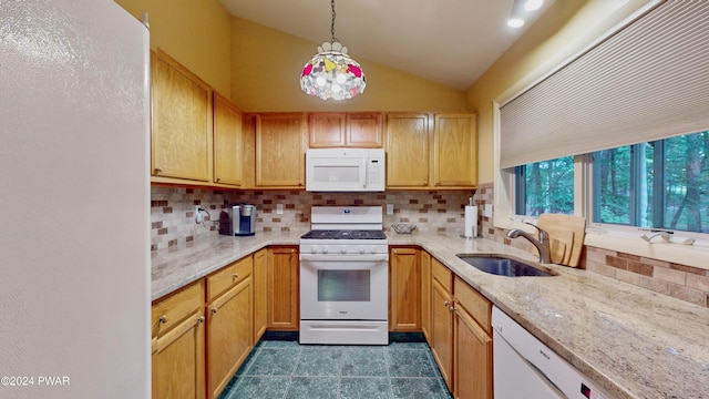 kitchen with pendant lighting, white appliances, backsplash, sink, and vaulted ceiling