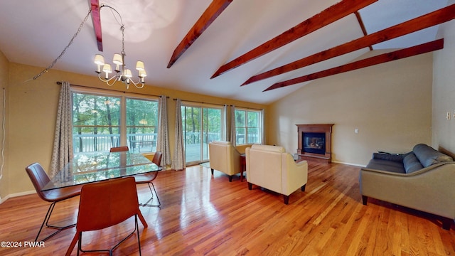 living room featuring a chandelier, lofted ceiling with beams, and hardwood / wood-style flooring