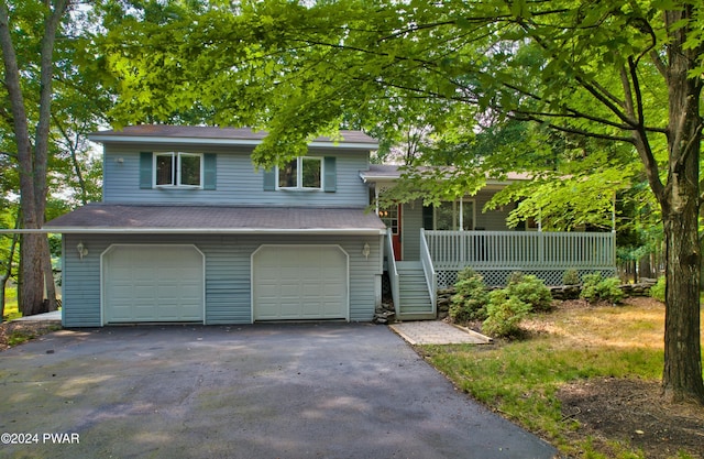 tri-level home featuring a porch and a garage