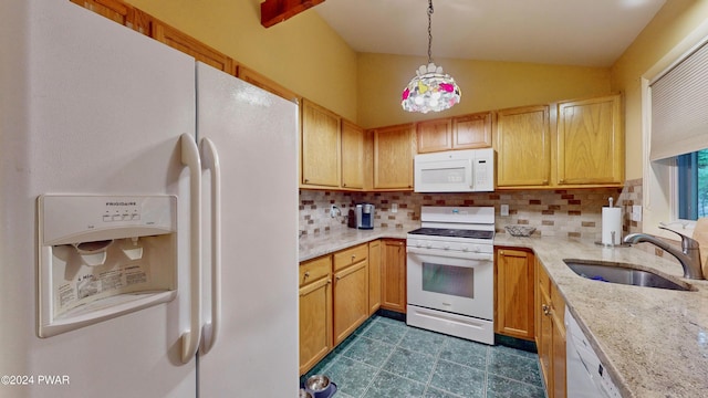 kitchen with backsplash, pendant lighting, white appliances, and sink