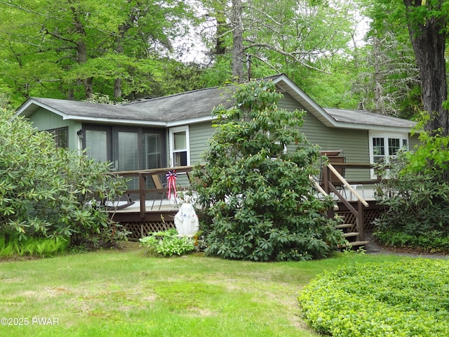 58 Branch Rd, Greentown, PA 18426 - back of house featuring a deck, roof with shingles, and a lawn