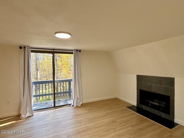 unfurnished living room with light hardwood / wood-style flooring and a wall of windows