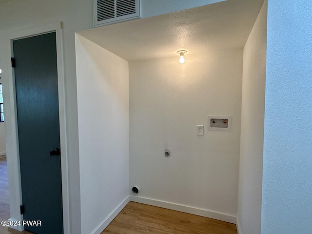 clothes washing area featuring hardwood / wood-style flooring, hookup for an electric dryer, and washer hookup