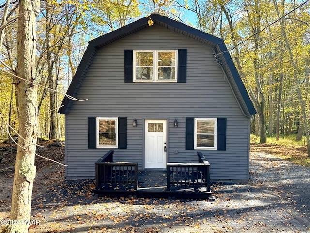 rear view of house featuring a wooden deck