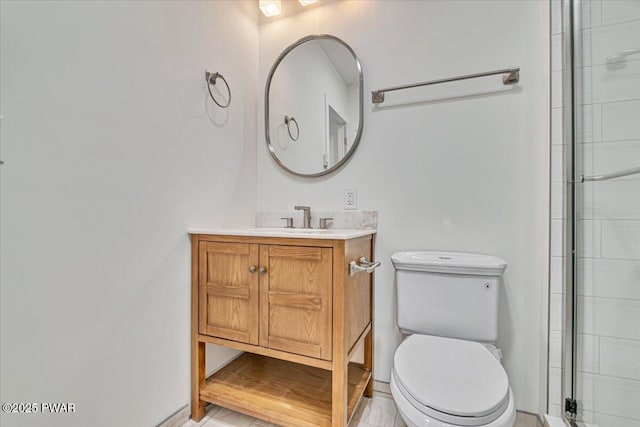 bathroom with vanity, toilet, and walk in shower