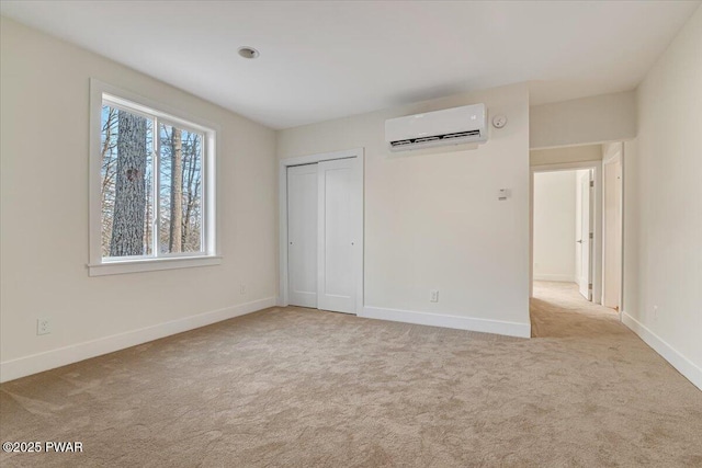 unfurnished bedroom featuring light colored carpet, a wall unit AC, and a closet