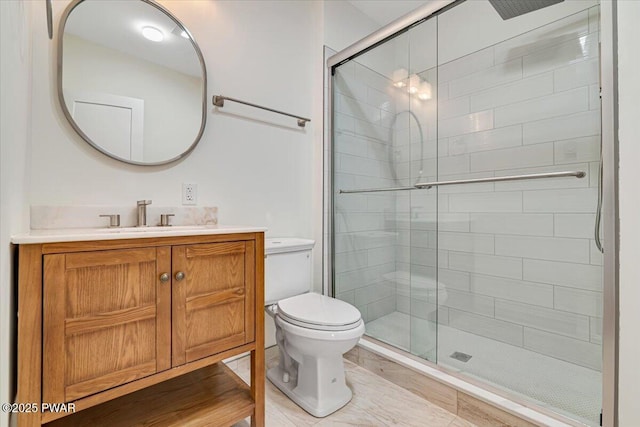 bathroom with vanity, walk in shower, and toilet