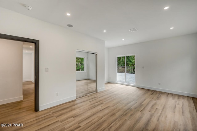 unfurnished room with light hardwood / wood-style floors