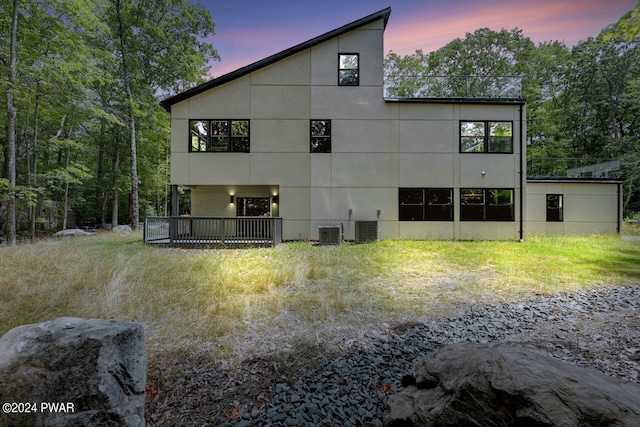 back house at dusk with central AC unit