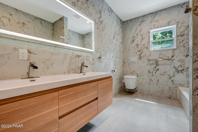 full bathroom featuring vanity, toilet, shower / bath combination, and tile walls