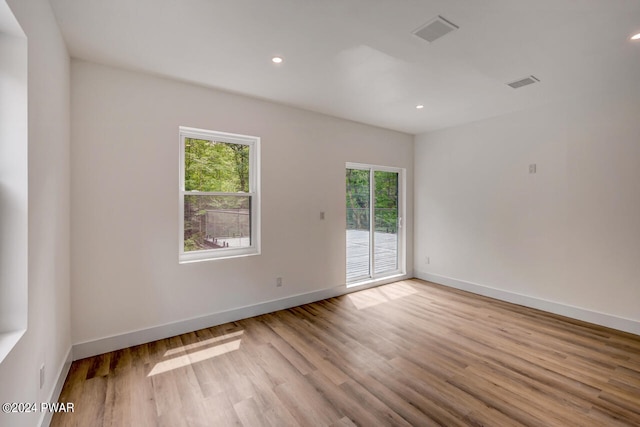 unfurnished room with light hardwood / wood-style floors