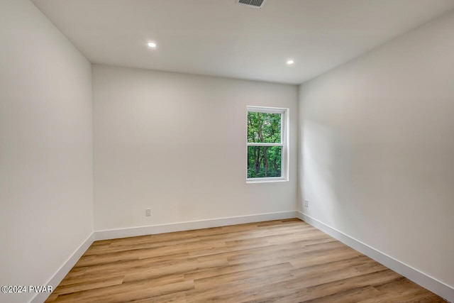 empty room with light hardwood / wood-style flooring