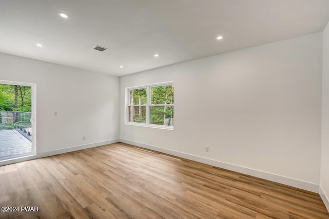 spare room with light hardwood / wood-style flooring