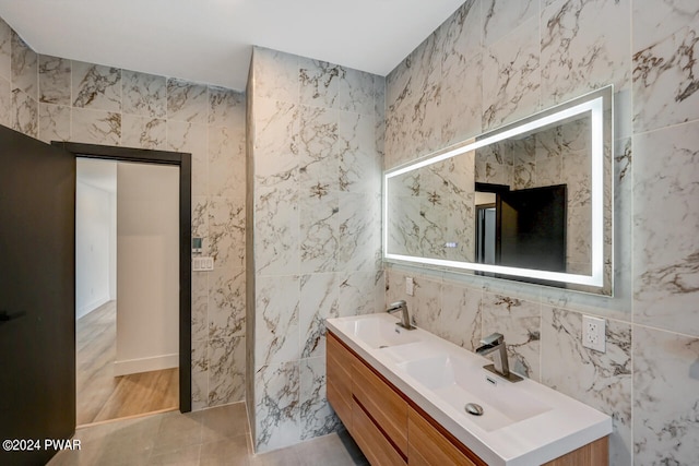 bathroom with vanity, tile patterned floors, and tile walls