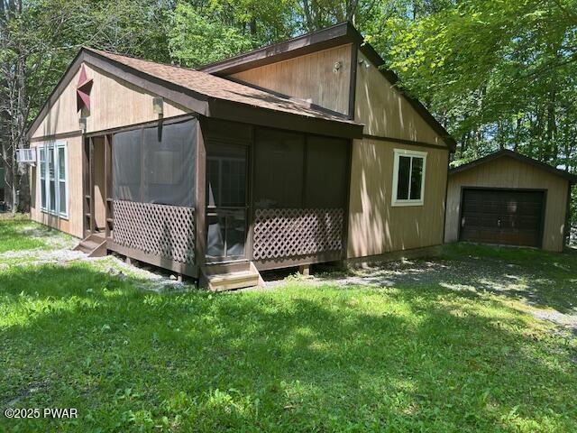 94 Cedarwood Ter, Lake Ariel, PA 18436 - view of property exterior with a garage, an outbuilding, a sunroom, and a yard