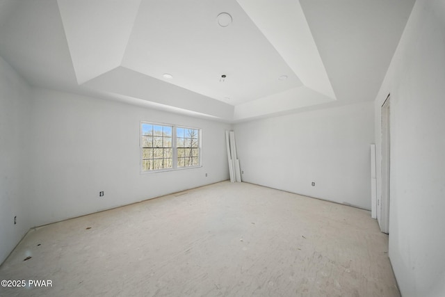 empty room featuring a raised ceiling