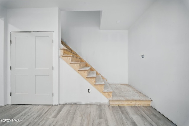 stairway featuring wood finished floors