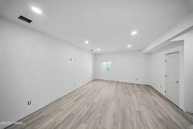 below grade area with light wood-type flooring and recessed lighting