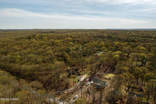 drone / aerial view featuring a view of trees