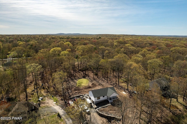 bird's eye view featuring a wooded view