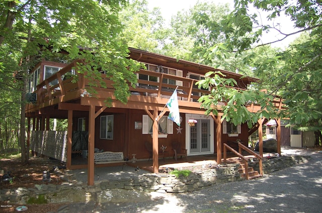 back of property with a wooden deck