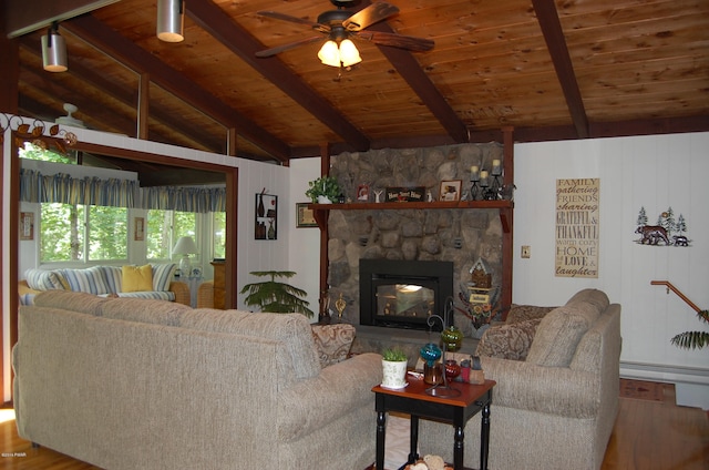 living room with wood ceiling, ceiling fan, hardwood / wood-style flooring, vaulted ceiling with beams, and a stone fireplace