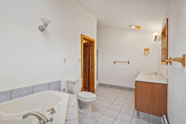 bathroom with tile patterned flooring, a relaxing tiled tub, a baseboard heating unit, toilet, and vanity