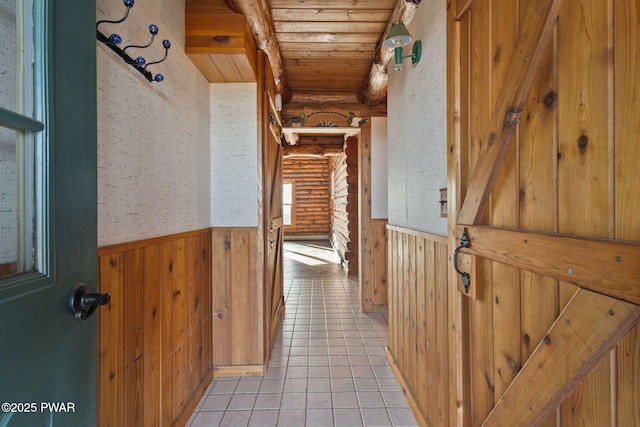 corridor with wood walls, wooden ceiling, and rustic walls