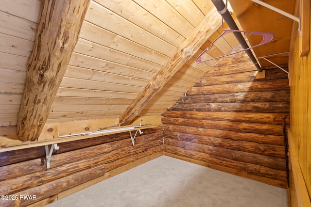 additional living space with wooden walls, beamed ceiling, carpet floors, and wooden ceiling