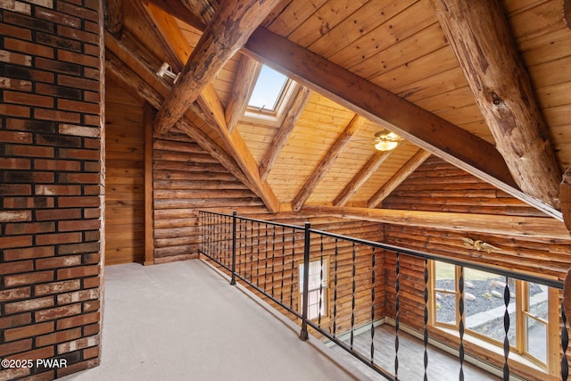 hallway with a skylight, rustic walls, a healthy amount of sunlight, wooden ceiling, and beamed ceiling