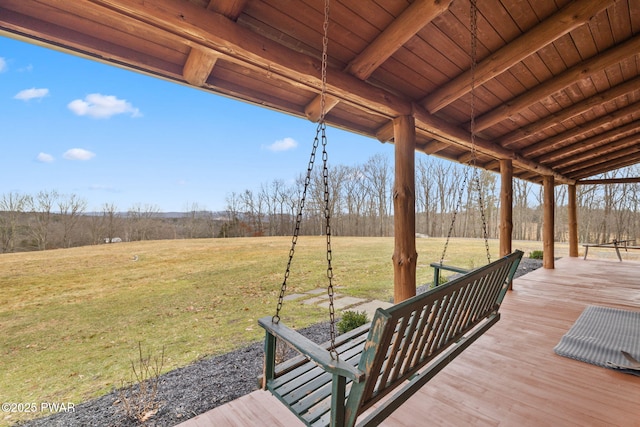 wooden terrace featuring a porch and a yard