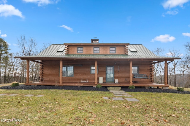 rear view of property with a yard and covered porch