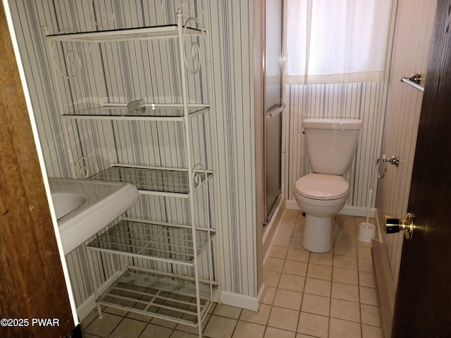 bathroom featuring toilet, tile patterned floors, and walk in shower