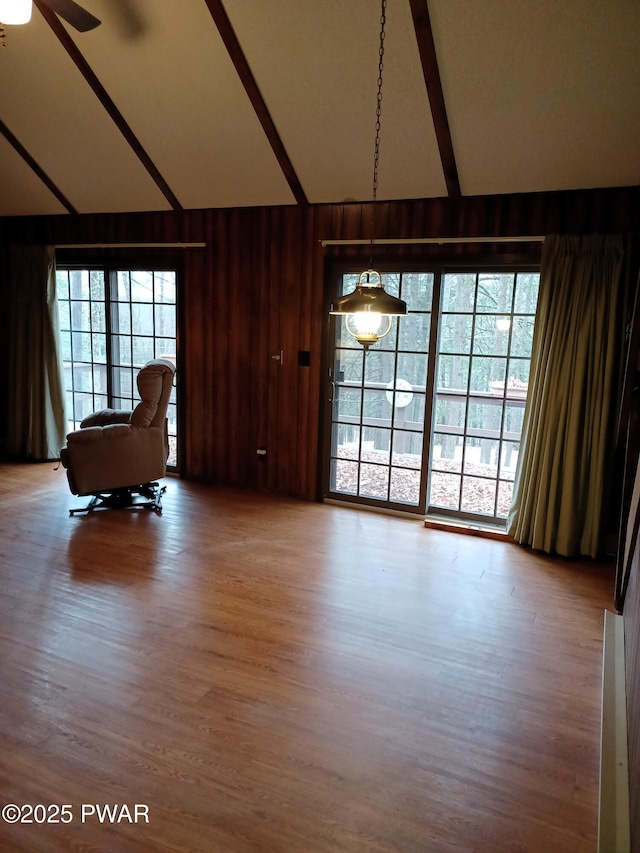 interior space featuring hardwood / wood-style flooring, ceiling fan, and vaulted ceiling