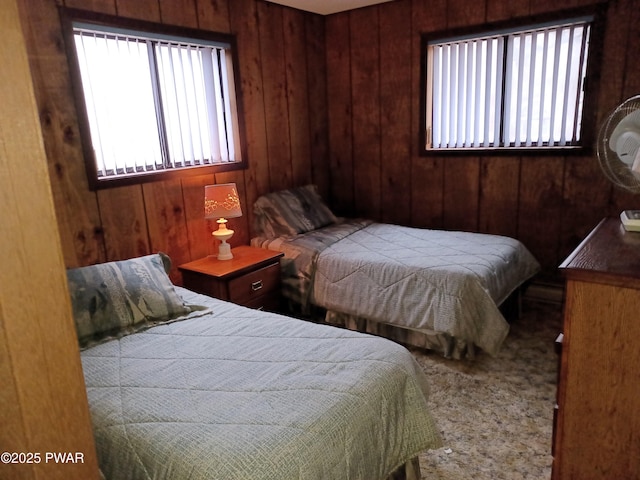 carpeted bedroom with wood walls