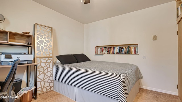 carpeted bedroom featuring baseboards and a ceiling fan