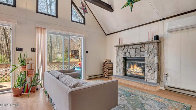 living area with high vaulted ceiling, a baseboard heating unit, wood finished floors, and a fireplace