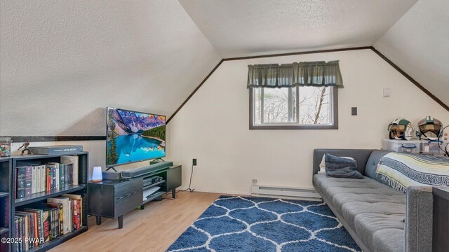 living room with a textured ceiling, wood finished floors, baseboard heating, and vaulted ceiling