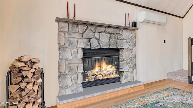 room details with ornamental molding, wood finished floors, a fireplace, baseboards, and a wall mounted air conditioner