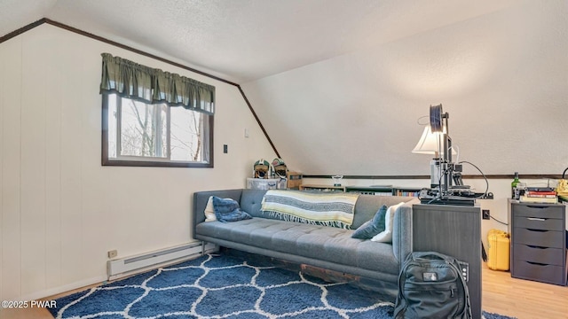 living area featuring a baseboard radiator, wood finished floors, and vaulted ceiling