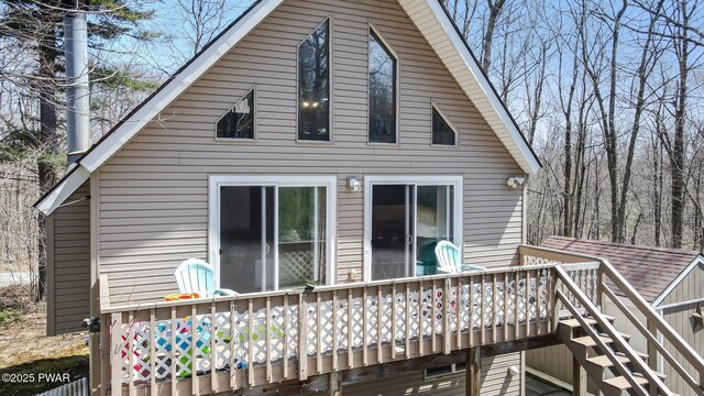 back of house with stairs and a deck