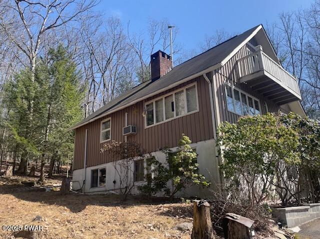 6 Ridge Vw, Hawley, PA 18428 - view of side of home with a wall mounted air conditioner, board and batten siding, and a chimney