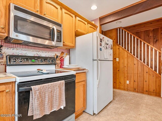 6 Ridge Vw, Hawley, PA 18428 - kitchen featuring electric range, stainless steel microwave, freestanding refrigerator, wooden walls, and light countertops