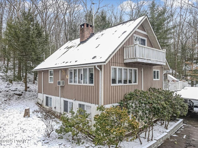 6 Ridge Vw, Hawley, PA 18428 - view of snow covered exterior with a balcony, cooling unit, board and batten siding, and a chimney