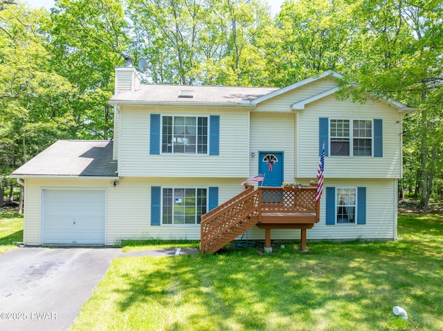 111 Babette Ct, Dingmans Ferry, PA 18328 - split foyer home with a chimney, an attached garage, driveway, and a front lawn