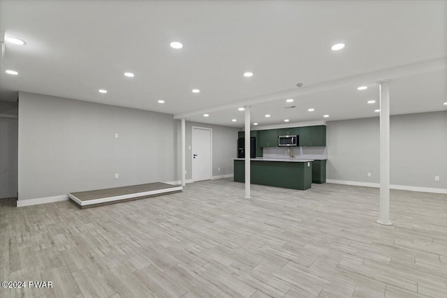1075 Owego Tpke, Honesdale, PA 18431 - finished below grade area featuring black refrigerator, light wood-style flooring, and recessed lighting