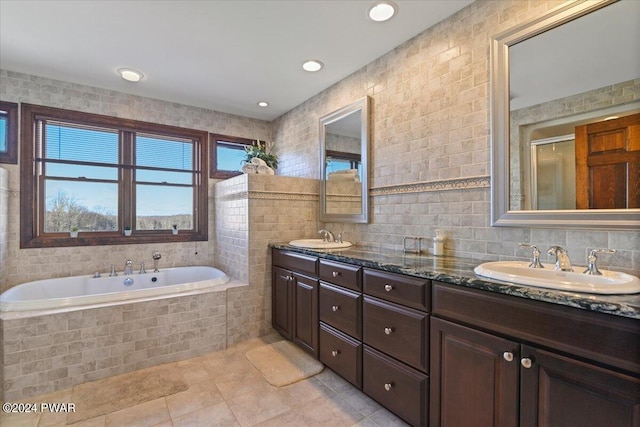 1075 Owego Tpke, Honesdale, PA 18431 - bathroom with double vanity, tile walls, tile patterned floors, a bath, and a shower with shower door