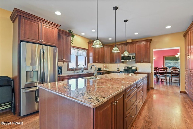 1075 Owego Tpke, Honesdale, PA 18431 - kitchen featuring appliances with stainless steel finishes, wood finished floors, light stone countertops, recessed lighting, and pendant lighting